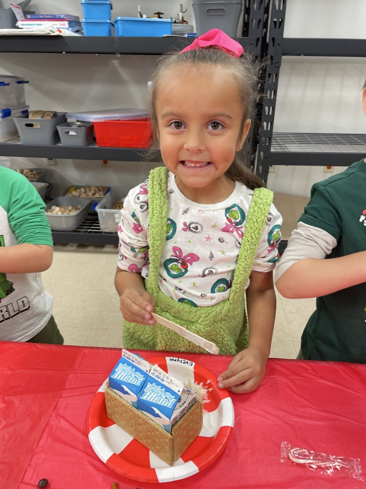 Kids making gingerbread houses.