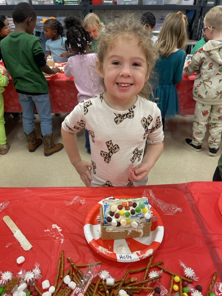 Kids making gingerbread houses.
