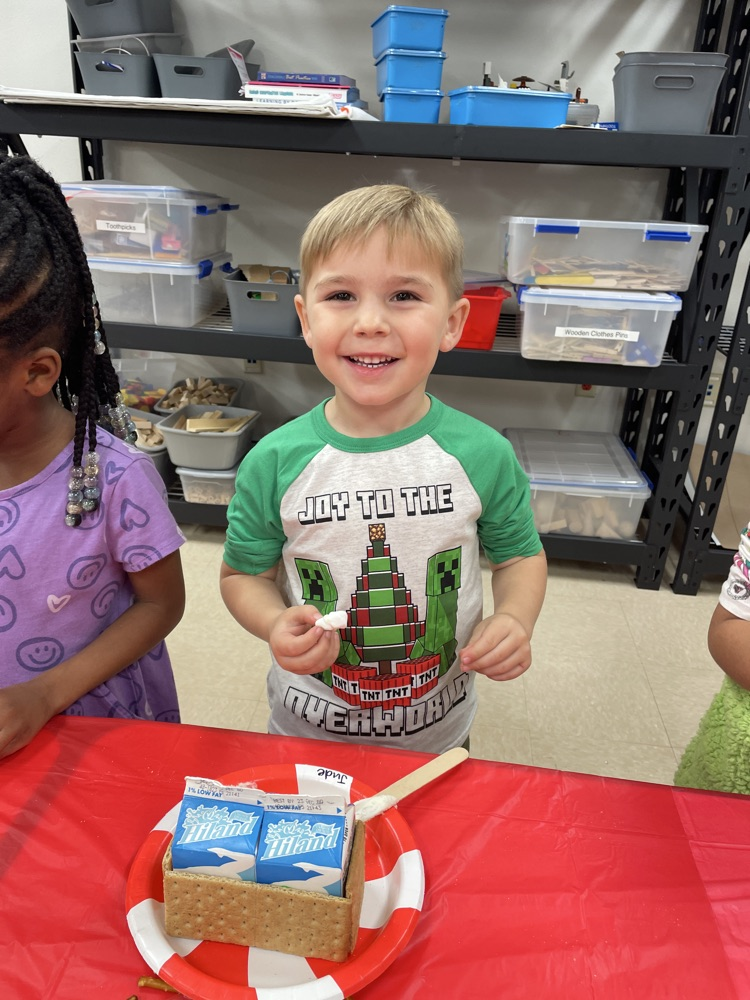 Kids making gingerbread houses.
