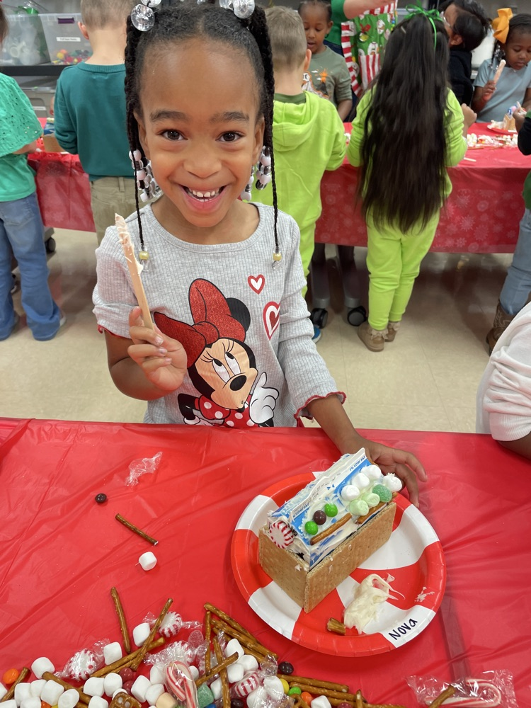 Kids making gingerbread houses.