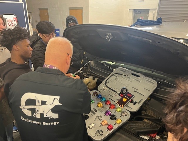 students working on radiator
