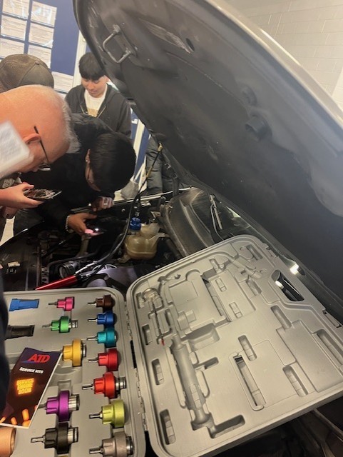 students working on radiator