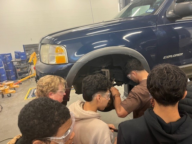 students working on brakes