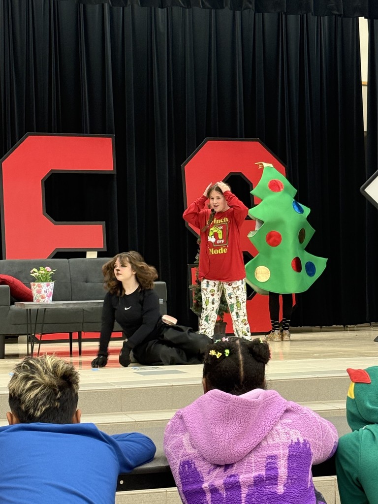 drama club performing a christmas play for a student audience