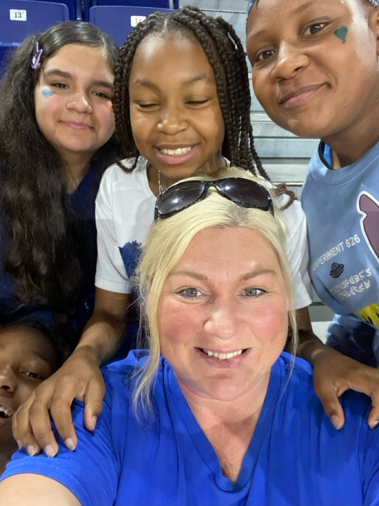 students smiling with teacher