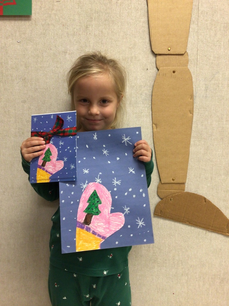 Students standing with their artwork made for Christmas Cards.