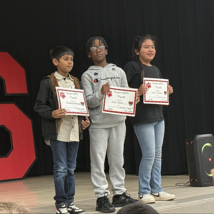 Student standing on the stage with their certificate