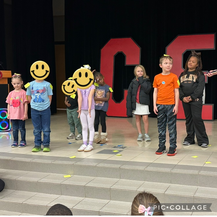 Student standing on the stage with sticky notes on them