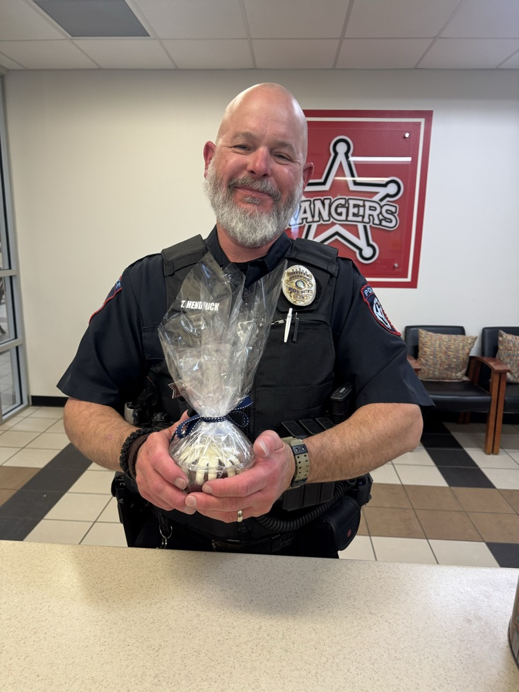 Officer Ty holding a cake 