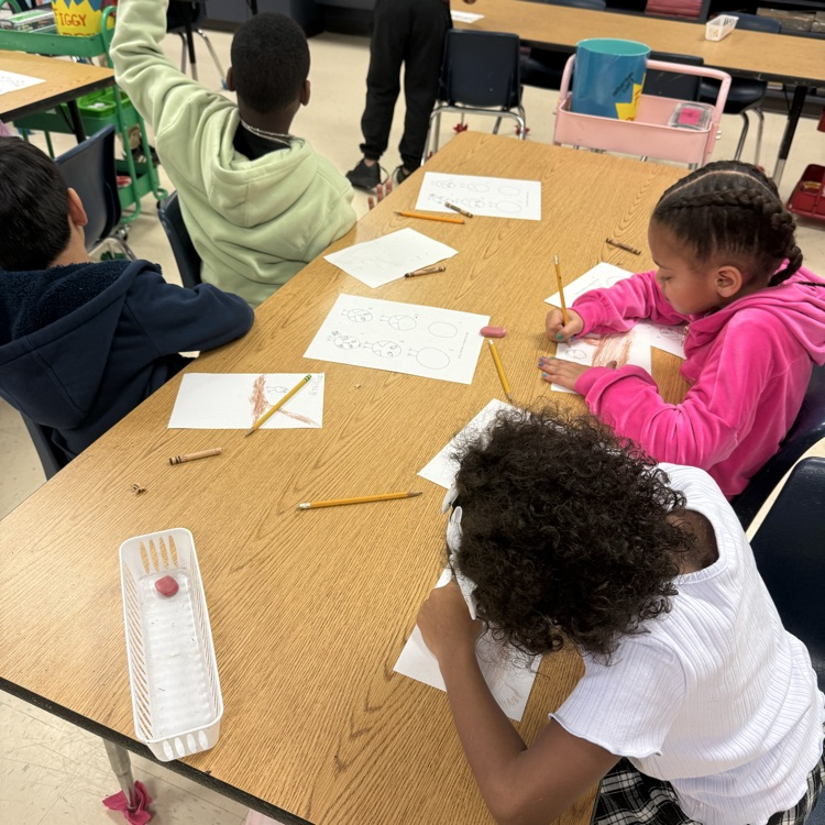 students working on their artwork and art class