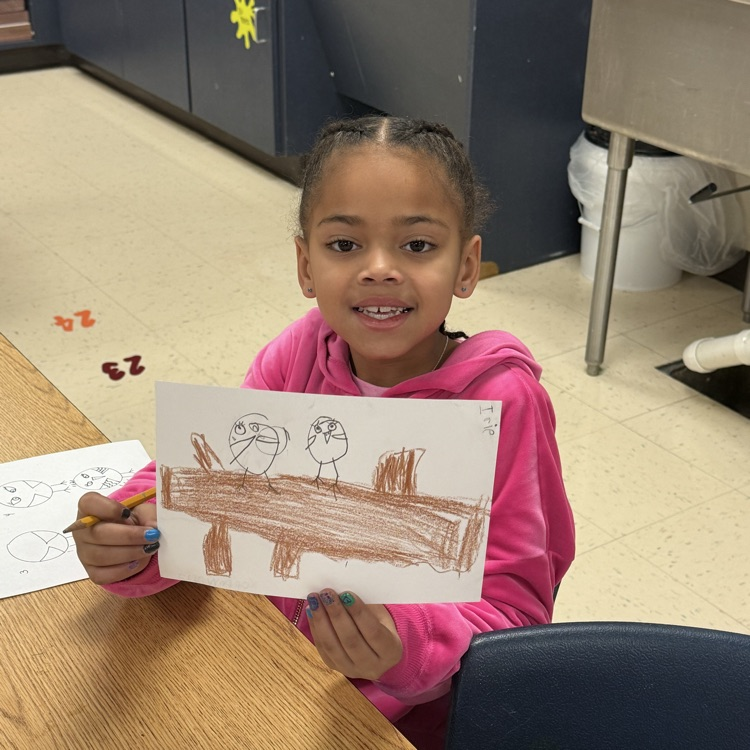 Student holding up artwork
