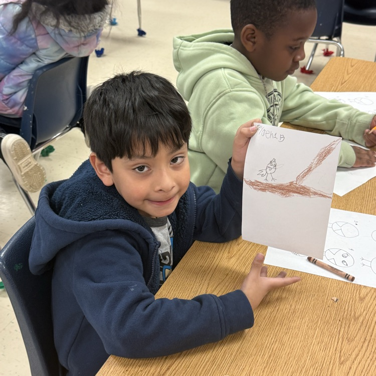 Student holding up artwork