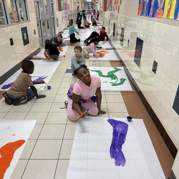 students painting in the hallway