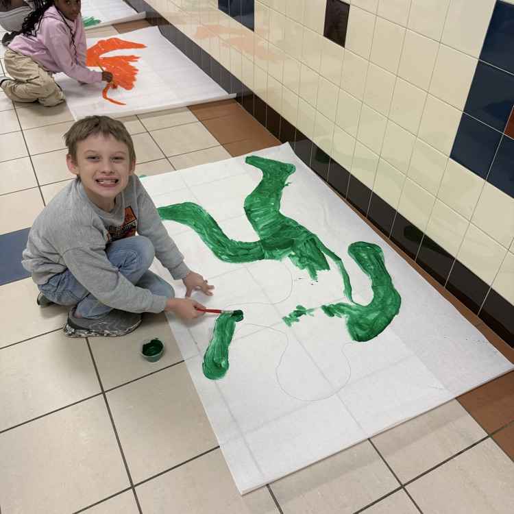 students painting in the hallway