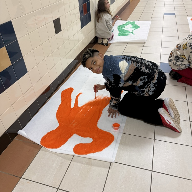 students painting in the hallway