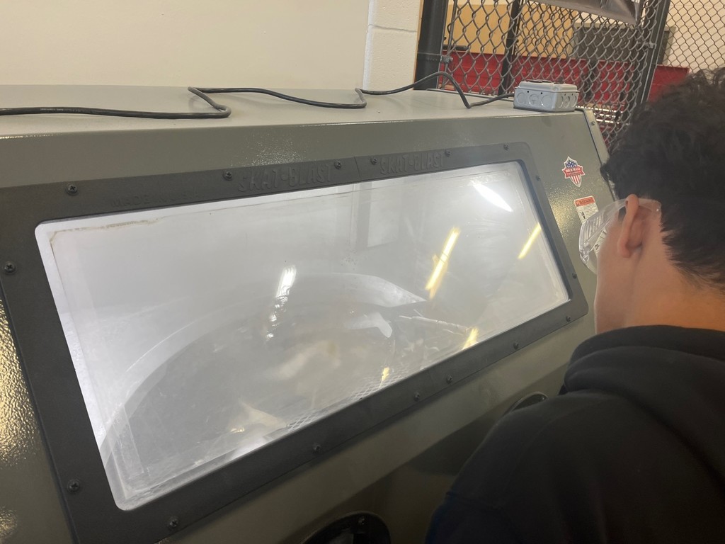 A closeup of the dry media blast cabinet at work.