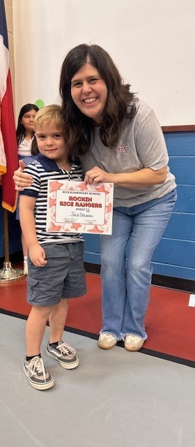 Student holding a certificate with teacher