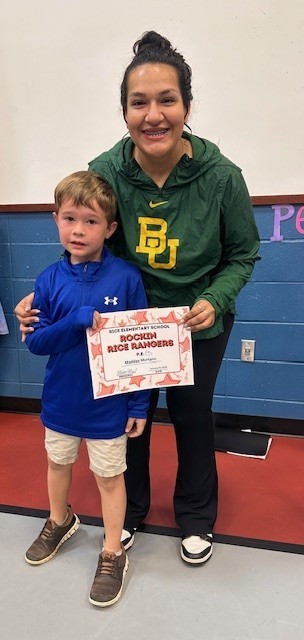 Student holding a certificate with teacher