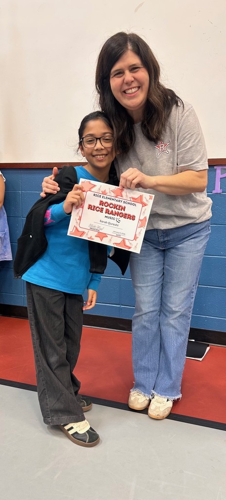 Student holding a certificate with teacher