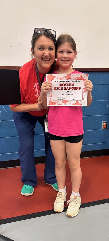 Student holding a certificate with teacher