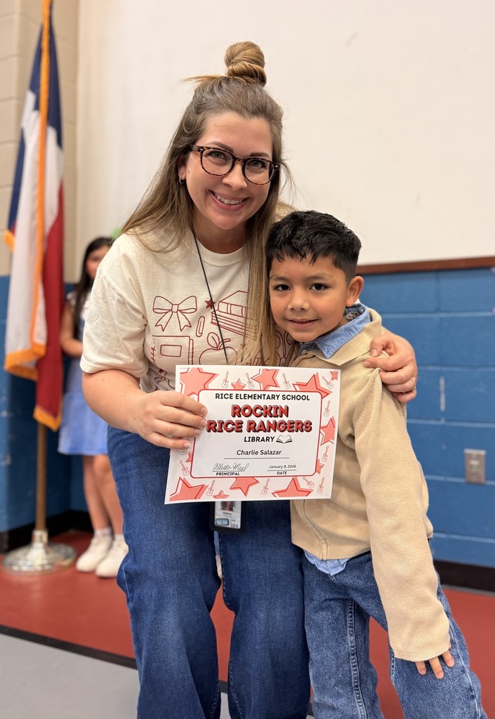 Student holding a certificate with teacher