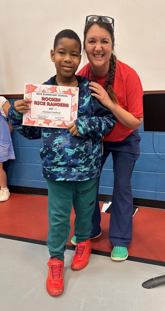 Student holding a certificate with teacher