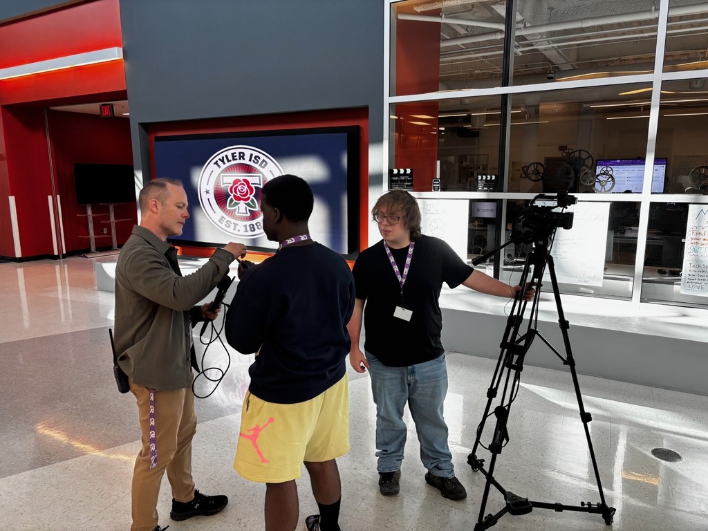 CTC Audio Video teacher helping students with audio/video equipment for interviews.