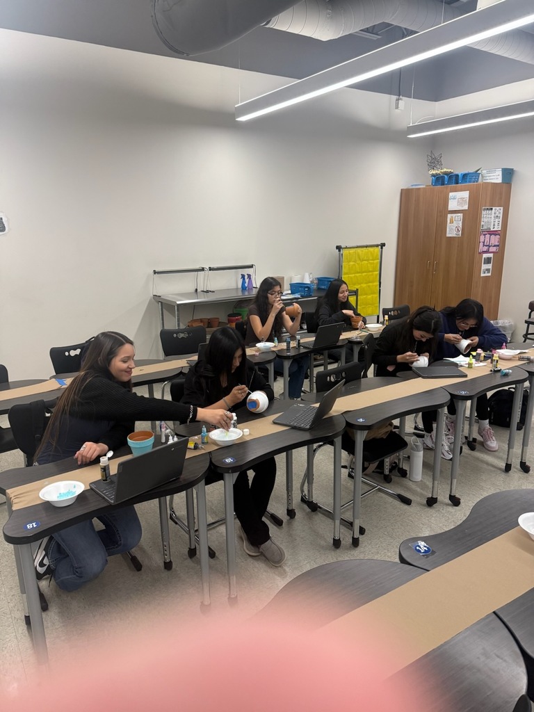 students painting flower pots