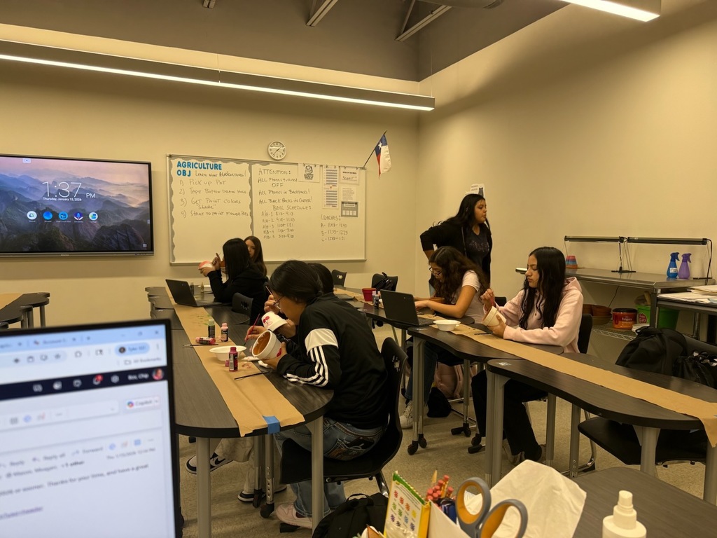 students painting flower pots