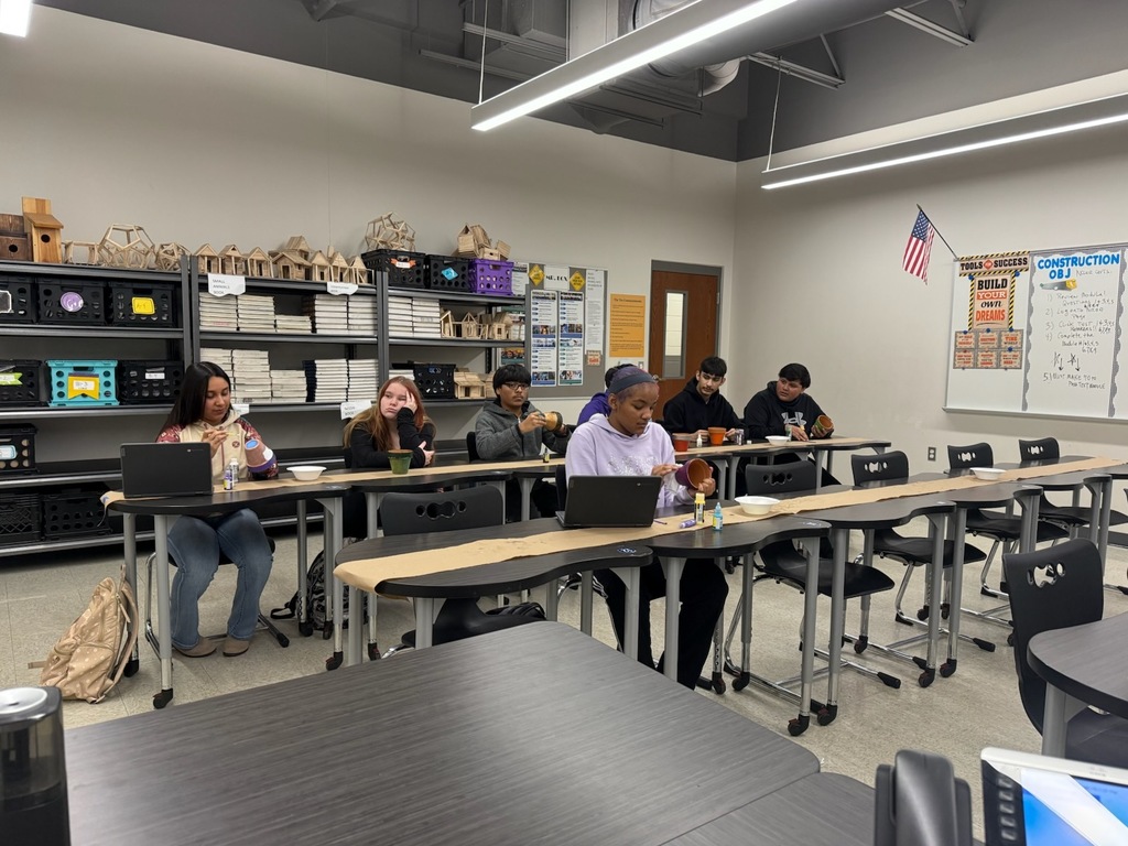 students painting flower pots
