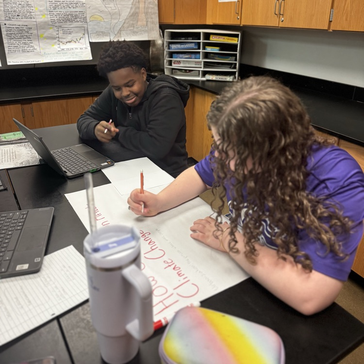 student collaboration on infographic posters over climate change