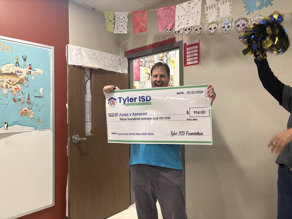 Mr. Kellerman holding his grant check