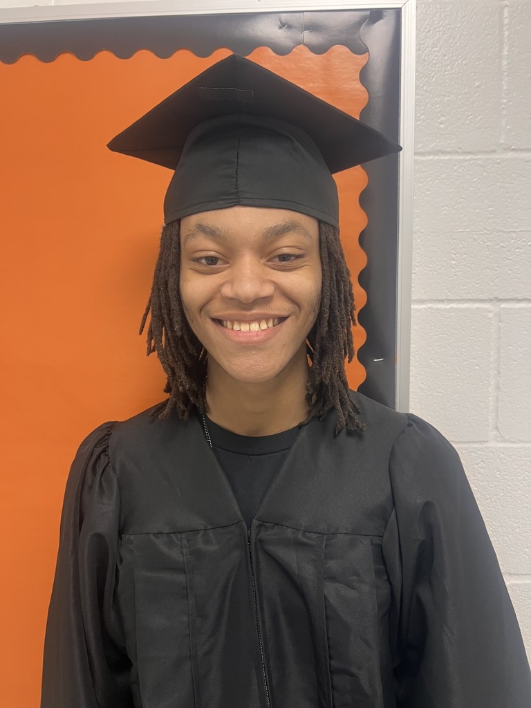 Student posing in graduation regalia