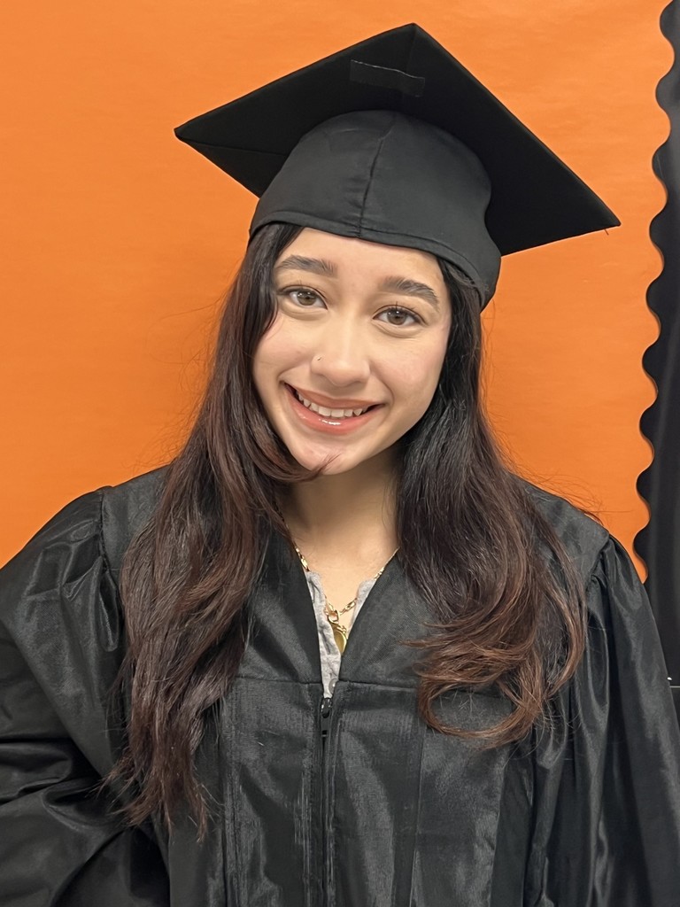 Student posing in graduation regalia