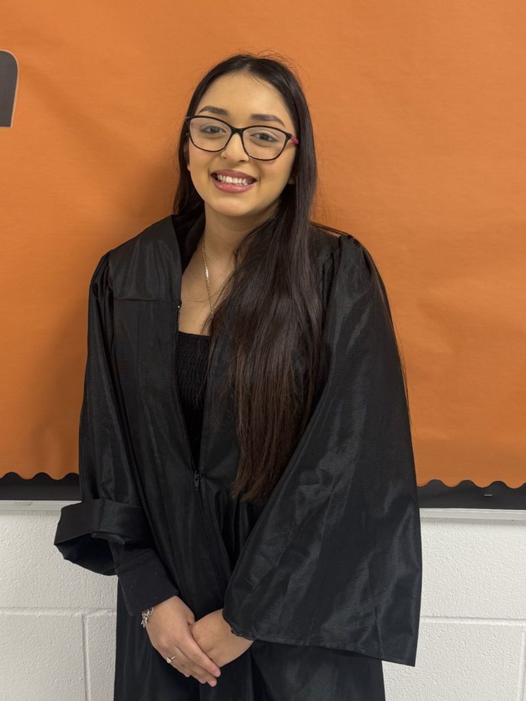 Student posing in graduation regalia