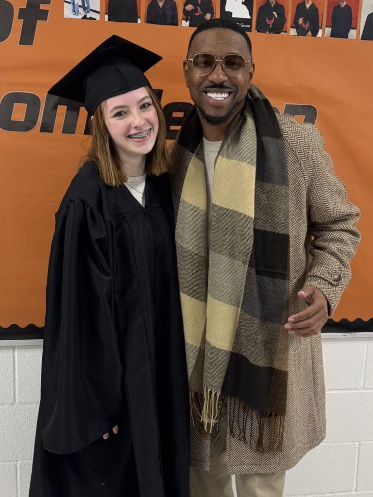 Student posing in graduation regalia