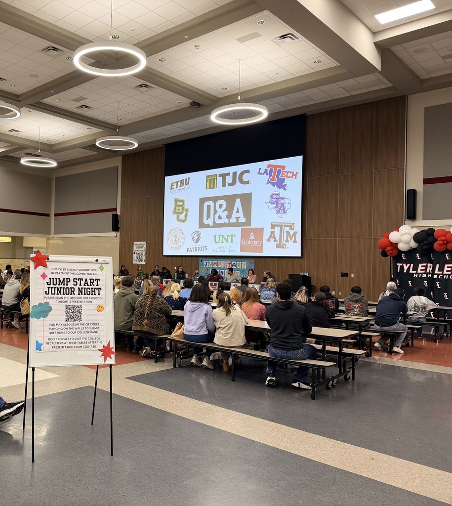 Tyler Legacy cafe during Jump start Junior Night. Families facing the stage with a presentation on the screen