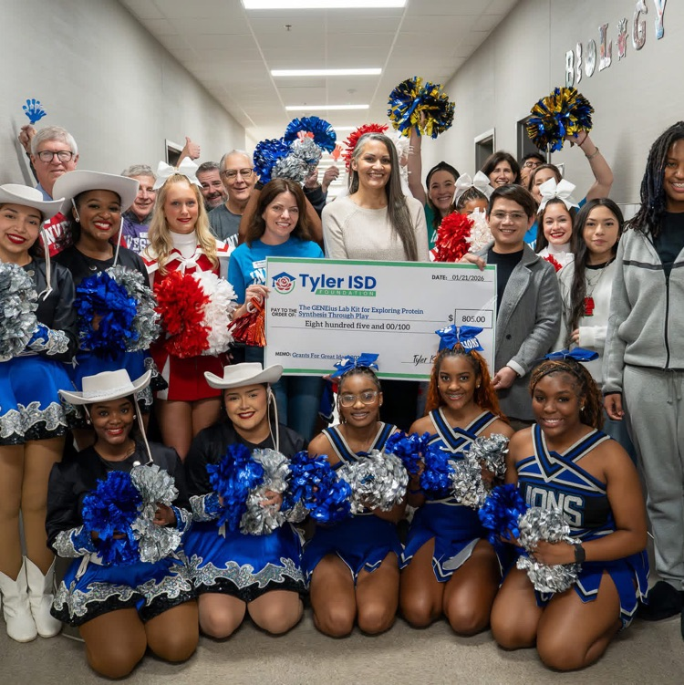 people holding a large check