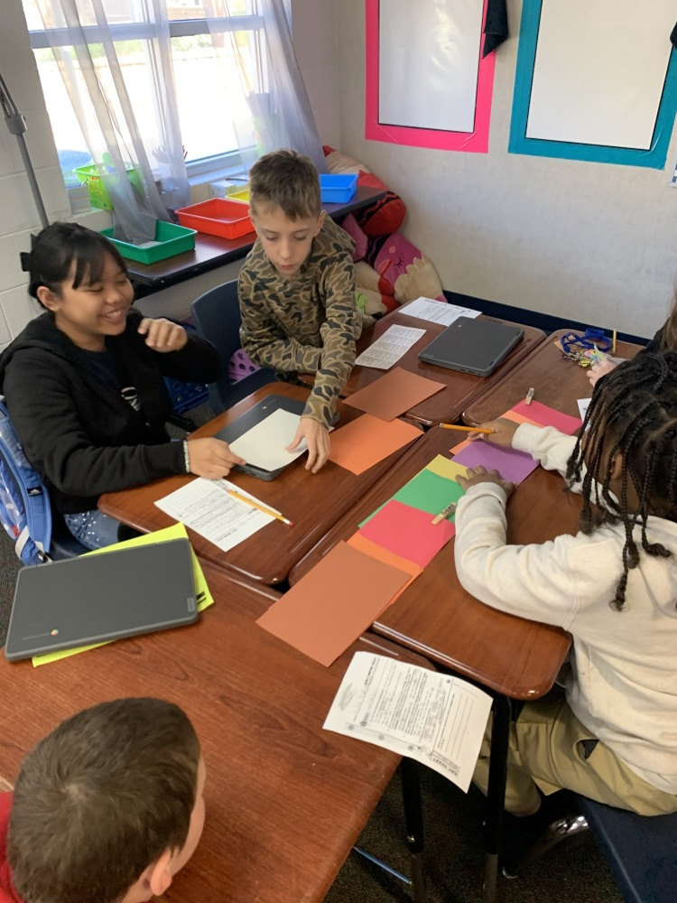students diagramming sentences at a group of desks