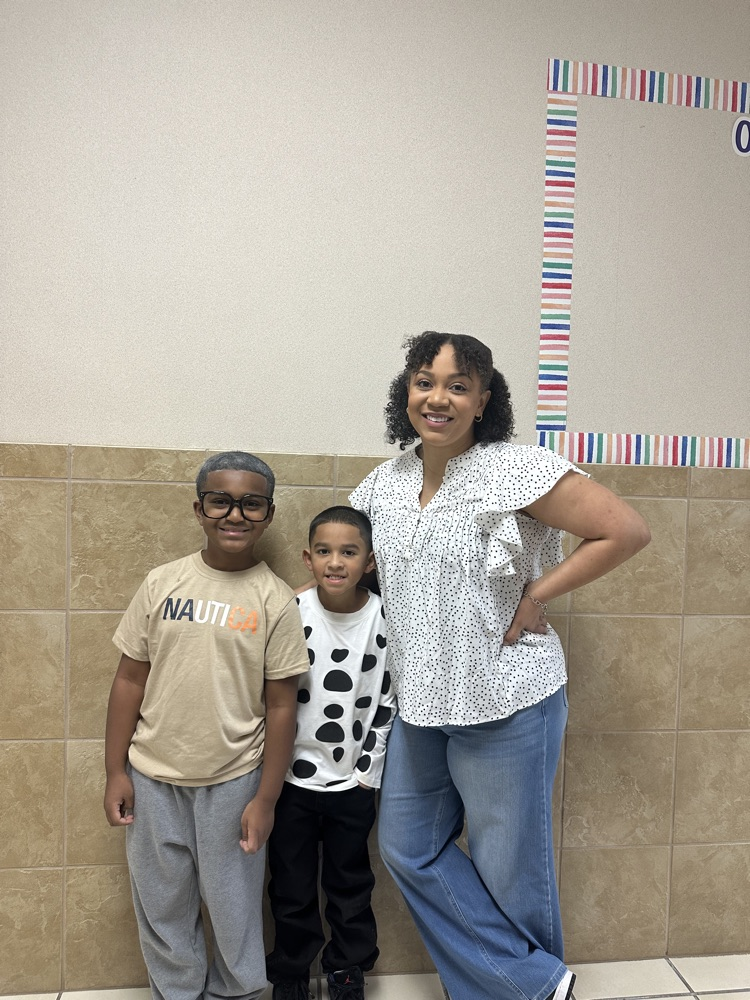 students and teacher smiling and posing 