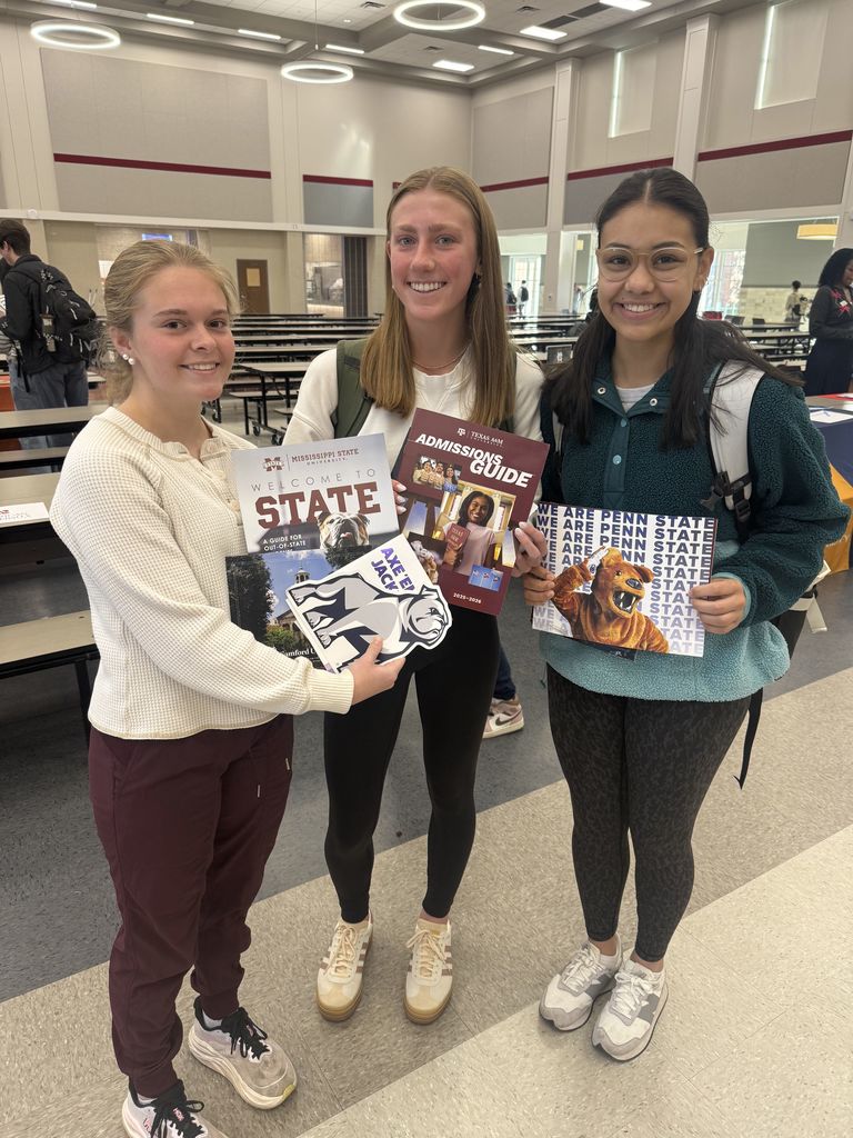 Tyler Legacy students holding college brochures while at the DARN college fair