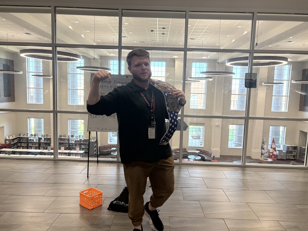 Tyler legacy's Walk Through Wednesday champion Mr. Smith holding the champion belt