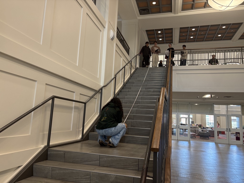 Students in Mr. Smith's class measuring the strairwell for their lesson