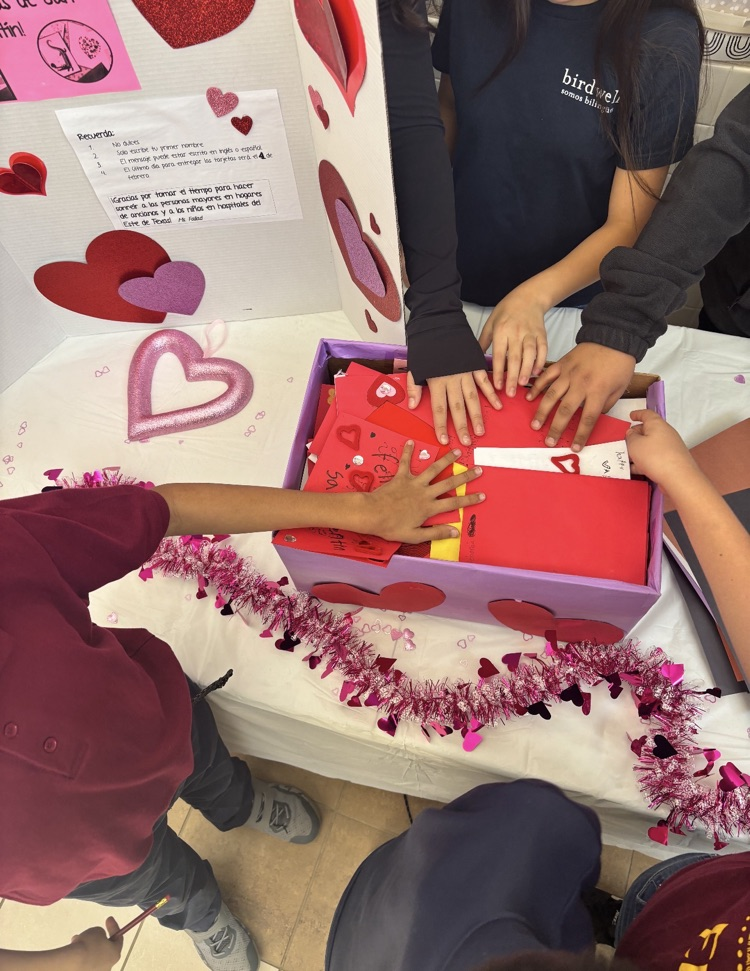 kids placing cards in the box