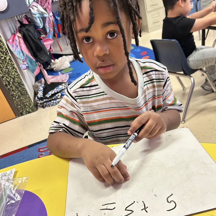 student working in a math small group