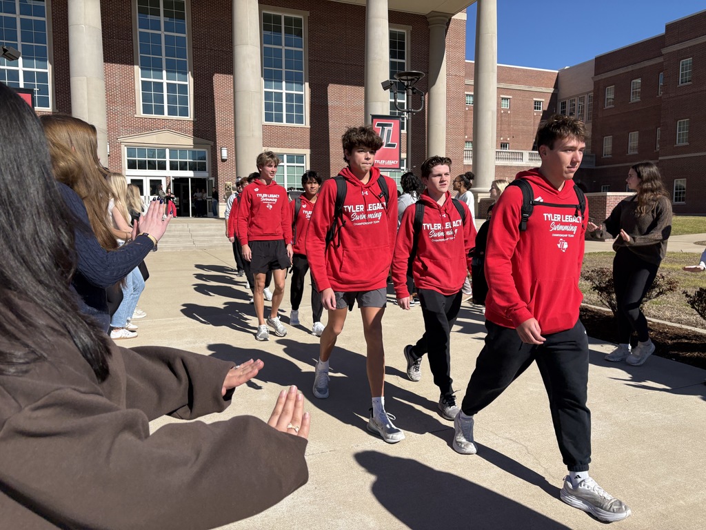 Swimmers walking out of Tyler Legacy during the send off for regionals