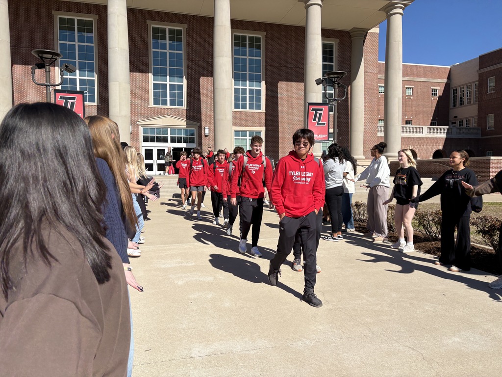 Swimmers walking out of Tyler Legacy during the send off for regionals