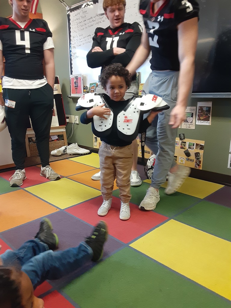Child wearing football shoulder pads