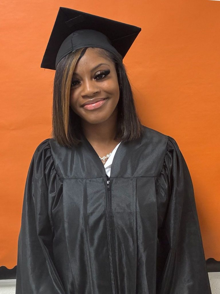 Student posing in graduation regalia