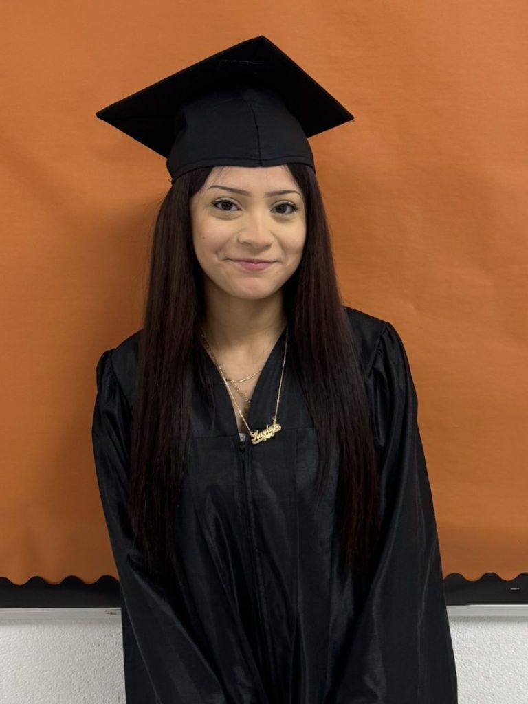 Student posing in graduation regalia